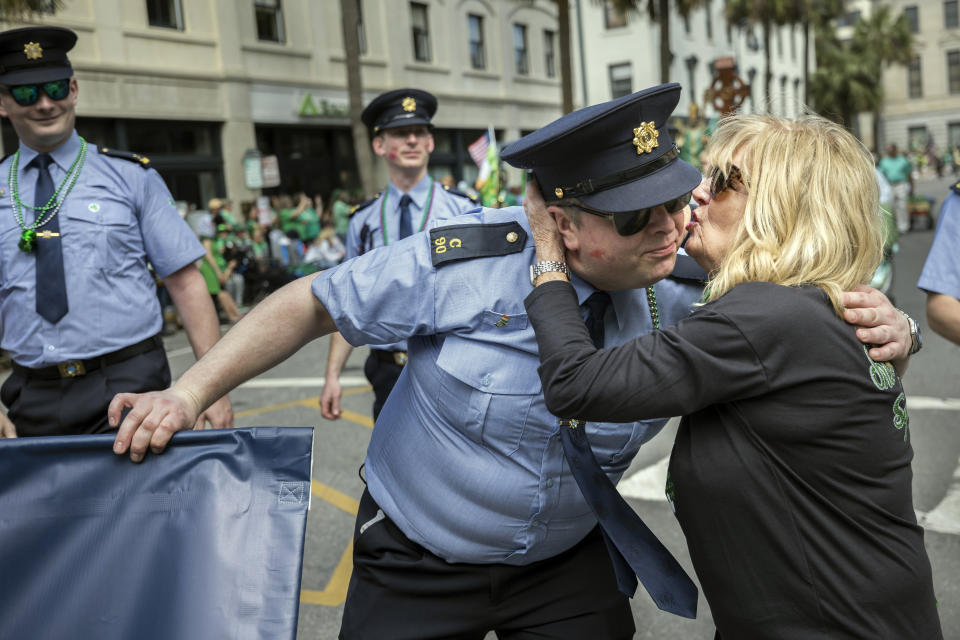 A member of the Garda Síochána, the national the national police and security service of Ireland, is kissed by a bystander during the 200th anniversary of Savannah''s St. Patrick's Day parade, Saturday, March 16, 2024, in Savannah, Ga. This is the 200th parade since the first in Georgia's oldest city that started in 1824. (Stephen B. Morton/Atlanta Journal-Constitution via AP)