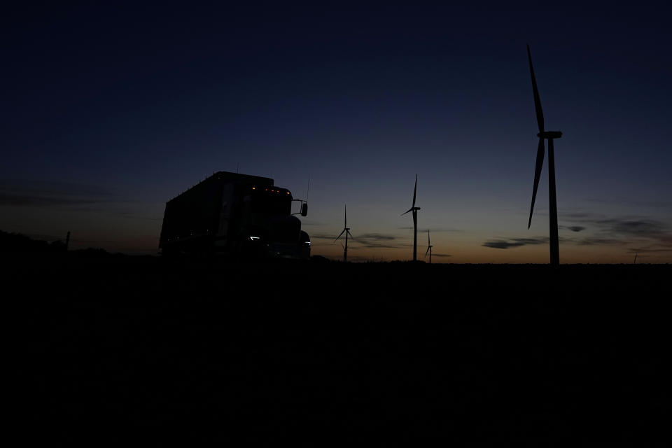 A truck passes a wind farm near Del Rio, Texas, Wednesday, Feb. 15, 2023. Some landowners along the Devil's River argue that proposed wind turbines would kill birds, bats and disrupt monarch butterflies migrating to Mexico and impact ecotourism, a main source of income for many. (AP Photo/Eric Gay)