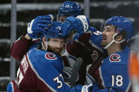 Colorado Avalanche left wing J.T. Compher (37) is congratulated by teammates Valeri Nichushkin (13) and Alex Newhook (18) after scoring a hat trick against the Los Angeles Kings during the second period of an NHL hockey game Wednesday, May, 12, 2021, in Denver. (AP Photo/Jack Dempsey)