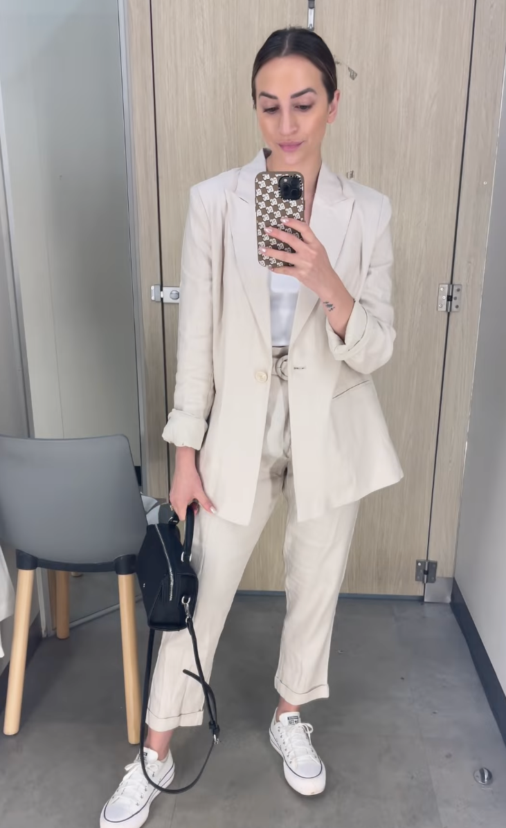 The stylist shows off a cream blazer and matching pants.