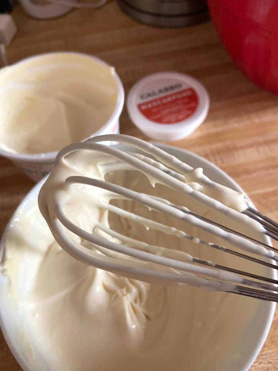 Whisk mixing a bowl of masrcapone mix for caramelized banana pudding