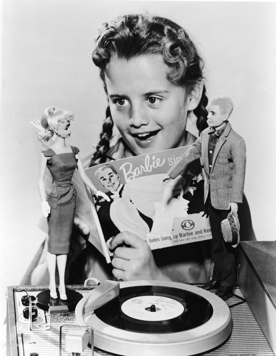 A girl sings beside her Barbie and Ken Doll to a song called “Barbie Sings” in 1961.