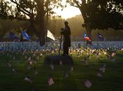 <p>The statue of a Civil War soldier stands amid flags placed by volunteer groups at the Los Angeles National Military Cemetery two days before Memorial Day in Los Angeles, Calif., on May 26, 2018. (Photo: Mark Ralston/AFP/Getty Images) </p>