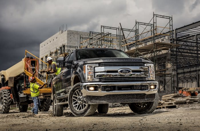 A black 2019 Ford F-350 Lariat, a heavy-duty pickup truck, on a construction site