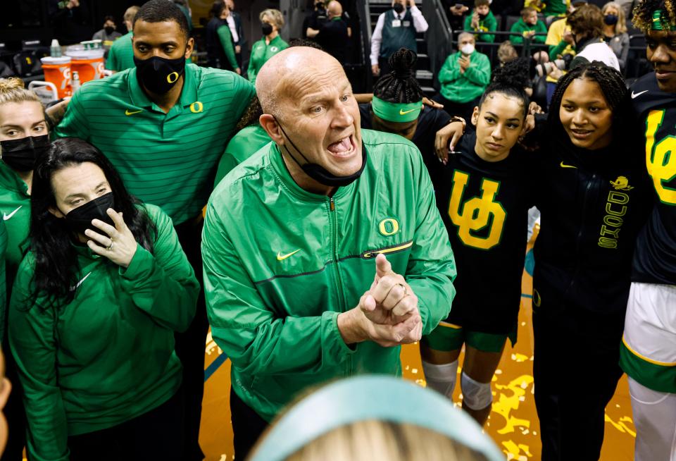Oregon head coach Kelly Graves, center, talks to his team before tip off for the first half of an NCAA college basketball game against Stanford in Eugene, Ore., Sunday, Feb. 20, 2022.
