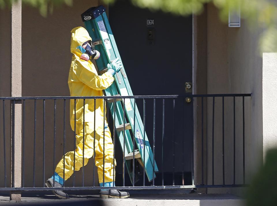 A worker wearing a hazardous material suit arrives at the apartment unit where a man diagnosed with the Ebola virus was staying in Dallas, Texas, October 3, 2014. (REUTERS/Jim Young)