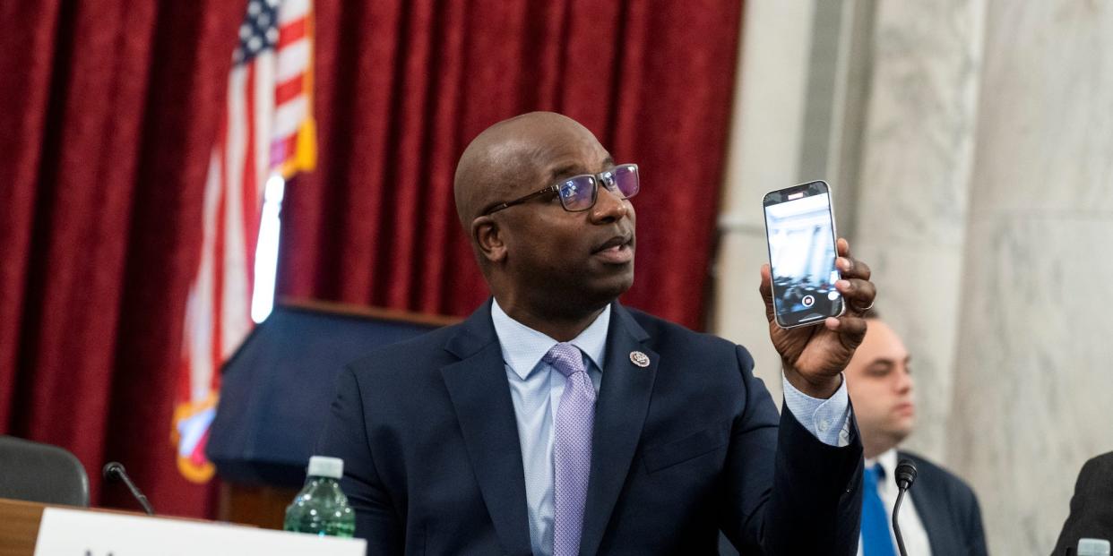 Democratic Rep. Jamaal Bowman of New York holds up a phone at the Capitol in May 2022.