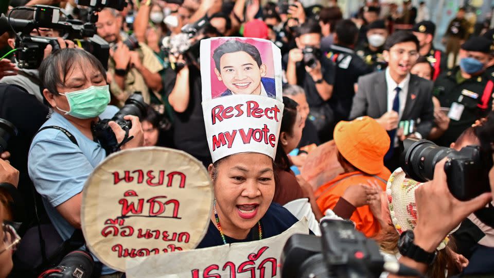 A supporter of former Thai prime ministerial candidate and ex-Move Forward Party leader Pita Limjaroenrat celebrates outside the Constitutional Court in Bangkok on January 24, 2024, after the court decided to reinstate him as a lawmaker. - Manan Vatsyayana/AFP/Getty Images