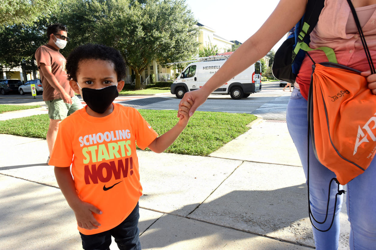 A boy arrives with his mother