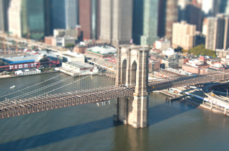 The Brooklyn Bridge in New York app is full of tiny cars crossing over.