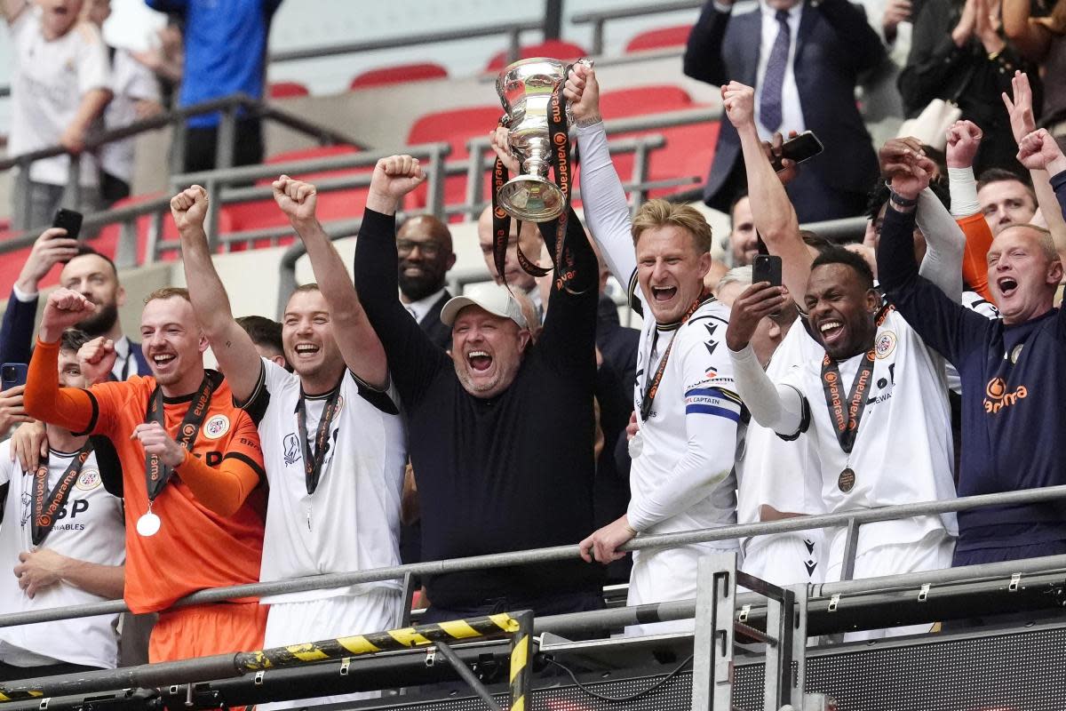 Bromley manager Andy Woodman lifts the play-off final trophy at Wembley <i>(Image: Nick Potts/ PA Wire)</i>