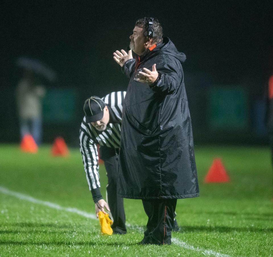 Harlem football coach Bob Moynihan complains about one of the 13 penalties called on the Huskies in their 17-7 loss Friday, Oct. 13, 2023 in the rain at Belvidere North