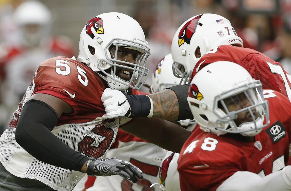 Arizona Cardinals defensive end Chandler Jones (55) tries to break away from offensive guard Mike Iupati, back right, as running back Derrick Coleman (48) makes a block during an NFL football practice Saturday, Aug. 4, 2018, in Glendale, Ariz. (AP Photo/Ross D. Franklin)