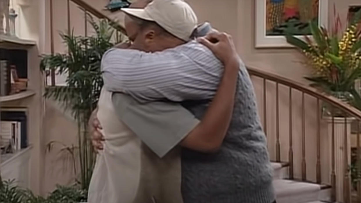  James Avery hugs Will Smith in the living room in The Fresh Prince of Bel Air. 