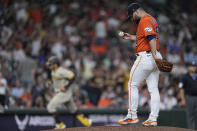 Houston Astros relief pitcher Jose Urquidy, front right, kicks at the mound after giving up a three-run home run to San Diego Padres' Trent Grisham during the eighth inning of a baseball game, Friday, Sept. 8, 2023, in Houston. (AP Photo/Kevin M. Cox)