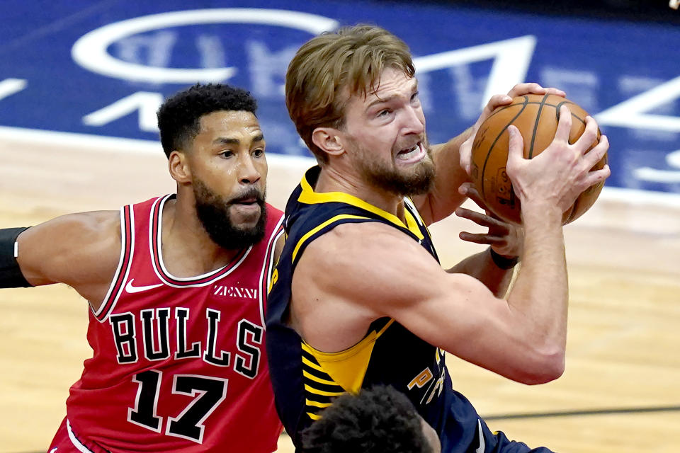 Indiana Pacers' Domantas Sabonis, right, drives past Chicago Bulls' Garrett Temple during the second half of an NBA basketball game Saturday, Dec. 26, 2020, in Chicago. (AP Photo/Charles Rex Arbogast)