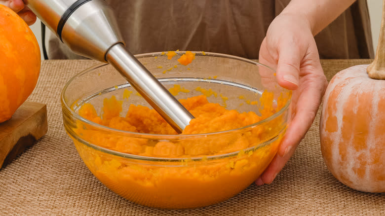 person making pumpkin puree