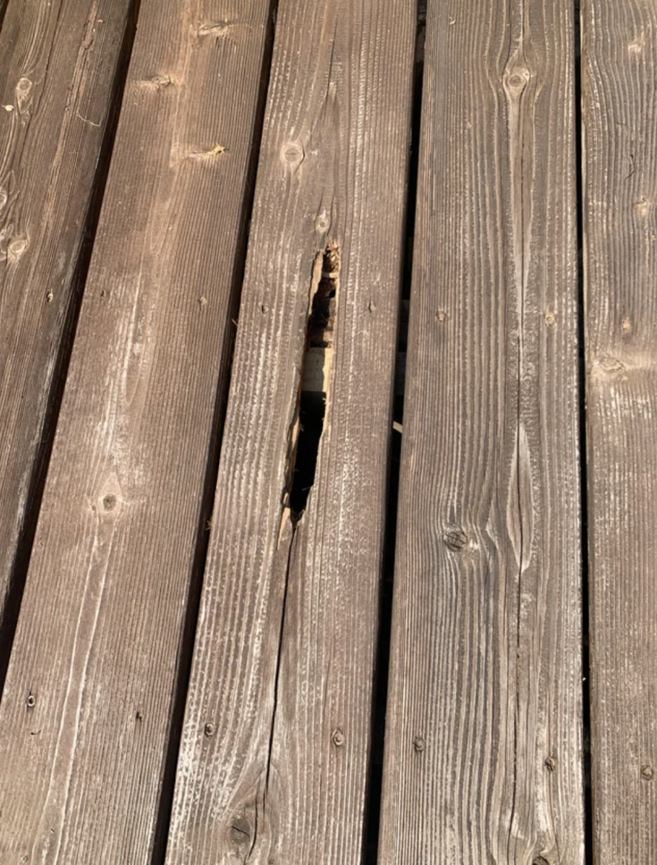 Damaged wooden deck with a prominent crack