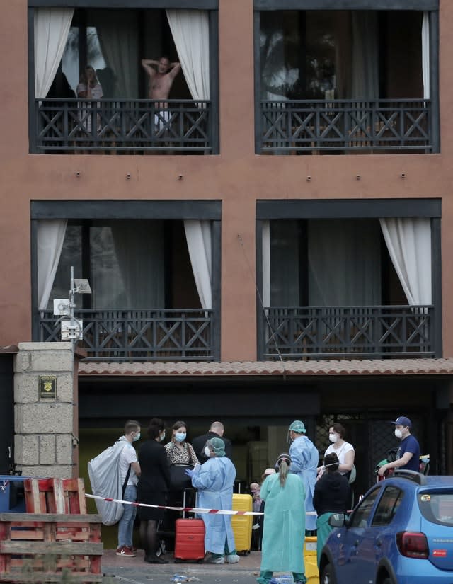 Guests leave the H10 Costa Adeje Palace hotel in Tenerife (Joan Mateu/AP)