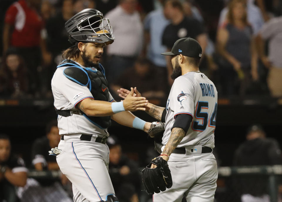 Miami Marlins catcher Jorge Alfaro, left, and relief pitcher Sergio Romo celebrate the team's 2-0 win over the Chicago White Sox after a baseball game Wednesday, July 24, 2019, in Chicago. (AP Photo/Charles Rex Arbogast)