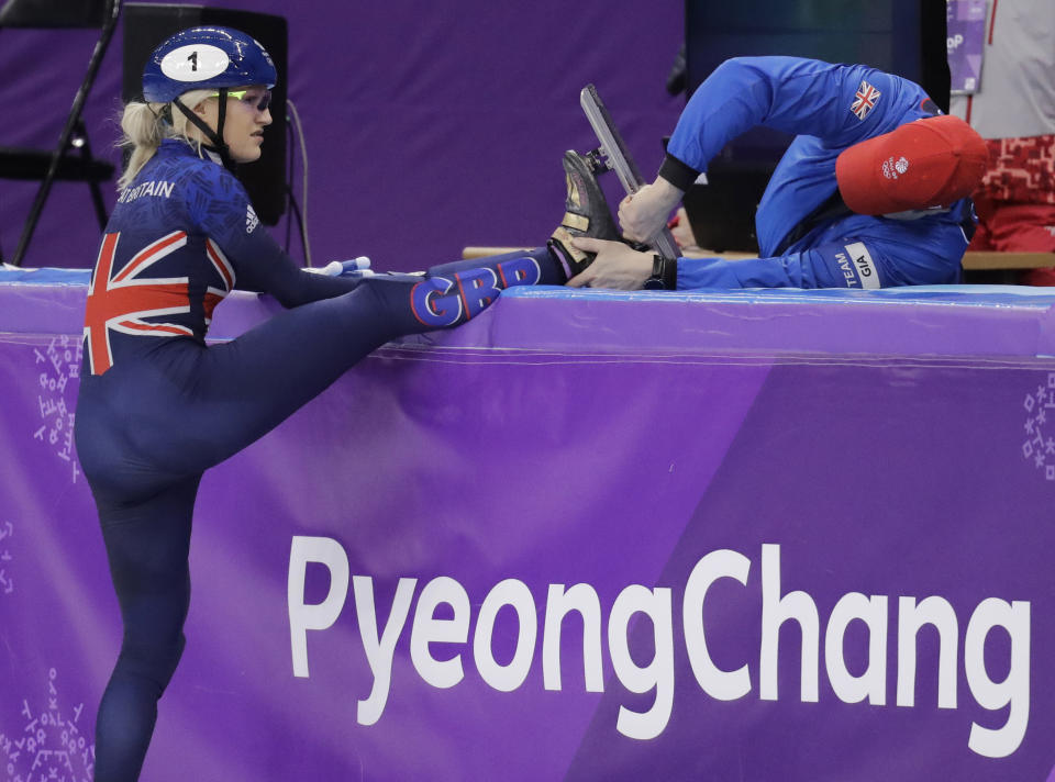 Elise Christie of Britain has repair work done to her skate after falling at the start of her women’s 1000 meters short track speedskating heat in the Gangneung Ice Arena at the 2018 Winter Olympics in Gangneung, South Korea, Tuesday, Feb. 20, 2018. (AP Photo/Aaron Favila)