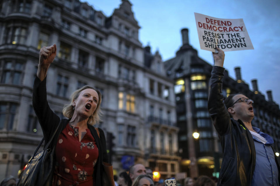 Anti-Brexit supporters take part in a protest in front of the Houses of Parliament in central London, Wednesday, Aug. 28, 2019. British Prime Minister Boris Johnson maneuvered on Wednesday to give his political opponents even less time to block a no-deal Brexit before the Oct. 31 withdrawal deadline, winning Queen Elizabeth II's approval to suspend Parliament. (AP Photo/Vudi Xhymshiti)