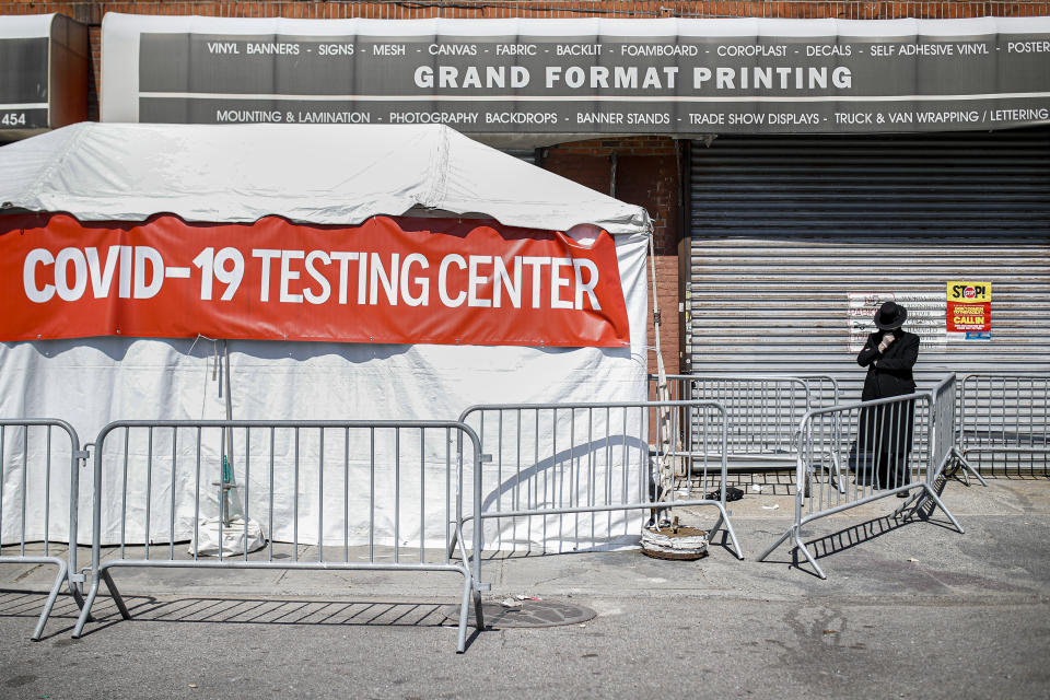 A COVID-19 testing tent is setup on a sidewalk in a predominantly Ultra-Orthodox neighborhood in the Brooklyn borough of New York, Friday, March 27, 2020. The new coronavirus causes mild or moderate symptoms for most people, but for some, especially older adults and people with existing health problems, it can cause more severe illness or death. (AP Photo/John Minchillo)