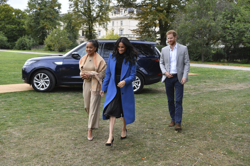 FILE - Meghan, the Duchess of Sussex, centre, accompanied by Britain's Prince Harry, the Duke of Sussex and her mother Doria Ragland walk to attend a reception at Kensington Palace, in London, Sept. 20, 2018. A spokesperson for Prince Harry and his wife Meghan said Wednesday, May 17, 2023 the couple were involved in a car chase while being followed by photographers. (Ben Stansall/Pool Photo via AP, file)