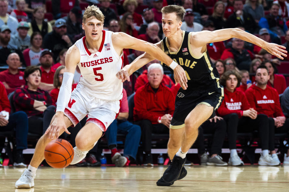 Nebraska's Sam Griesel (5) drives the ball to the basket past Purdue's Brian Waddell during the first half of an NCAA college basketball game, Saturday, Dec. 10, 2022, at Pinnacle Bank Arena in Lincoln, Neb. (Kenneth Ferriera/Lincoln Journal Star via AP)