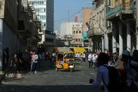 Iraqi demonstrators run during the ongoing anti-government protests in Baghdad