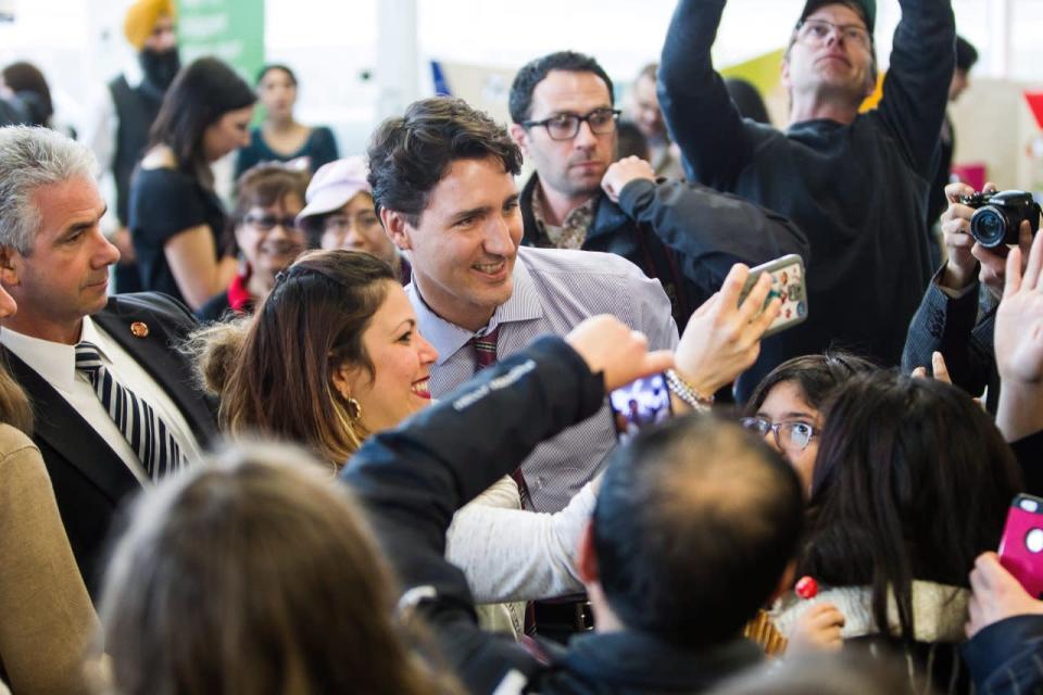 Prime Minister Justin Trudeau poses for photos with supporters during a stop at the Mill Woods branch of Edmonton Public Library in Edmonton Alta, on Wednesday March 30, 2016. THE CANADIAN PRESS/Codie McLachlan