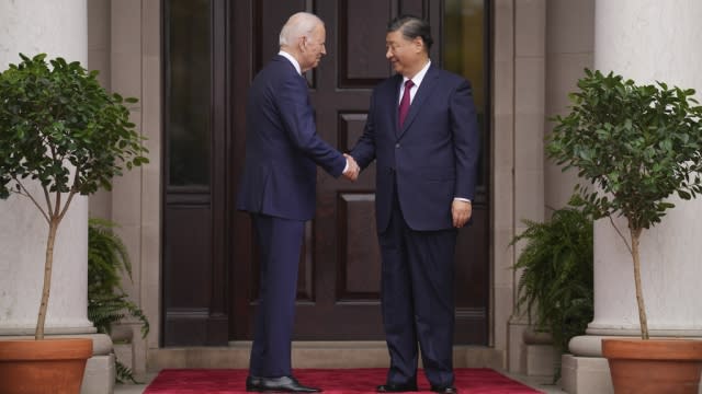 American and Chinese flags fly next to each other