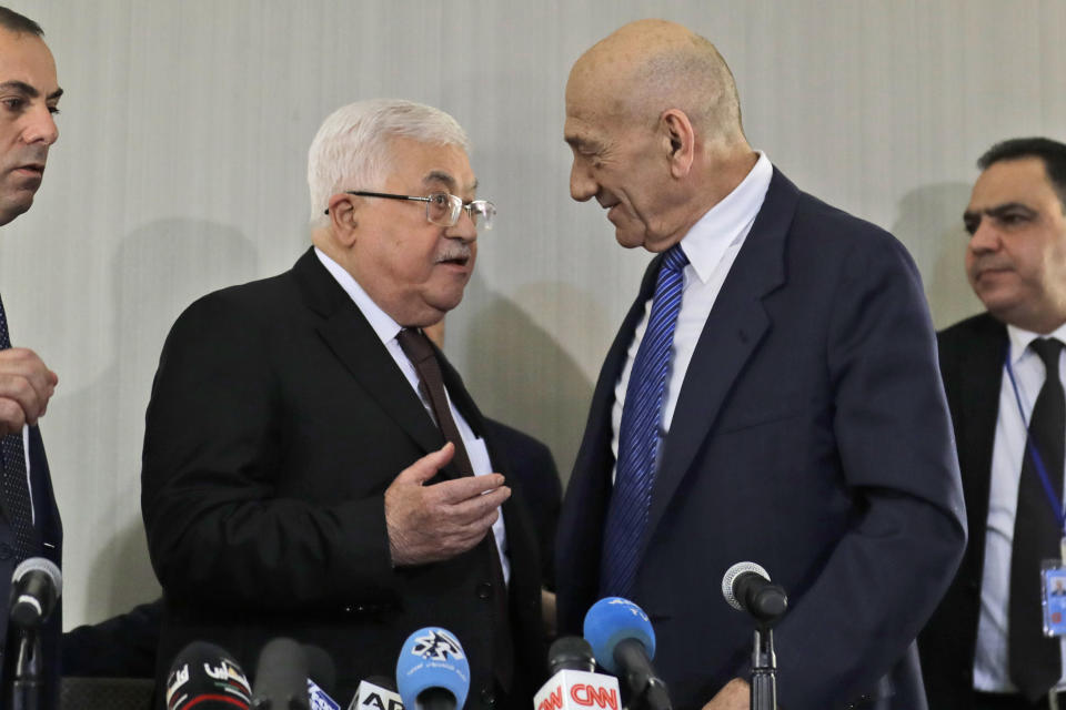 Palestinian President Mahmoud Abbas, left, speaks with former Israeli Prime Minister Ehud Olmert after a news conference in New York, Tuesday, Feb. 11, 2020. (AP Photo/Seth Wenig)