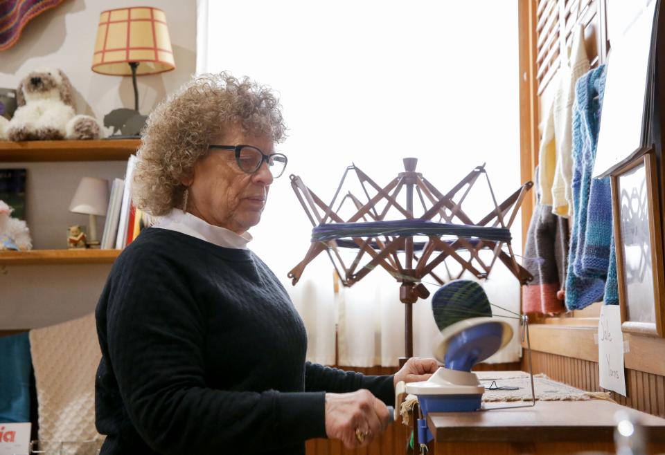 Edyie Stika rolls a ball of yarn Friday, March 1, 2024 at The Knitting Shoppe in Iowa City, Iowa.