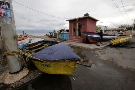 Boats are secured off as residents look on at Port Royal while Hurricane Matthew approaches in Kingston, Jamaica October 2, 2016. REUTERS/Henry Romero