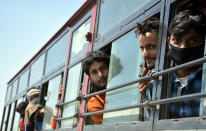 GHAZIABAD, INDIA - MARCH 28: Migrant workers seen inside a bus bound to their native state during Day 4 of the 21 day nationwide lockdown -- to check the spread of coronavirus, at Lal Kuan bus stand, on March 28, 2020 in Ghaziabad, India. (Photo by Sakib Ali/Hindustan Times via Getty Images)