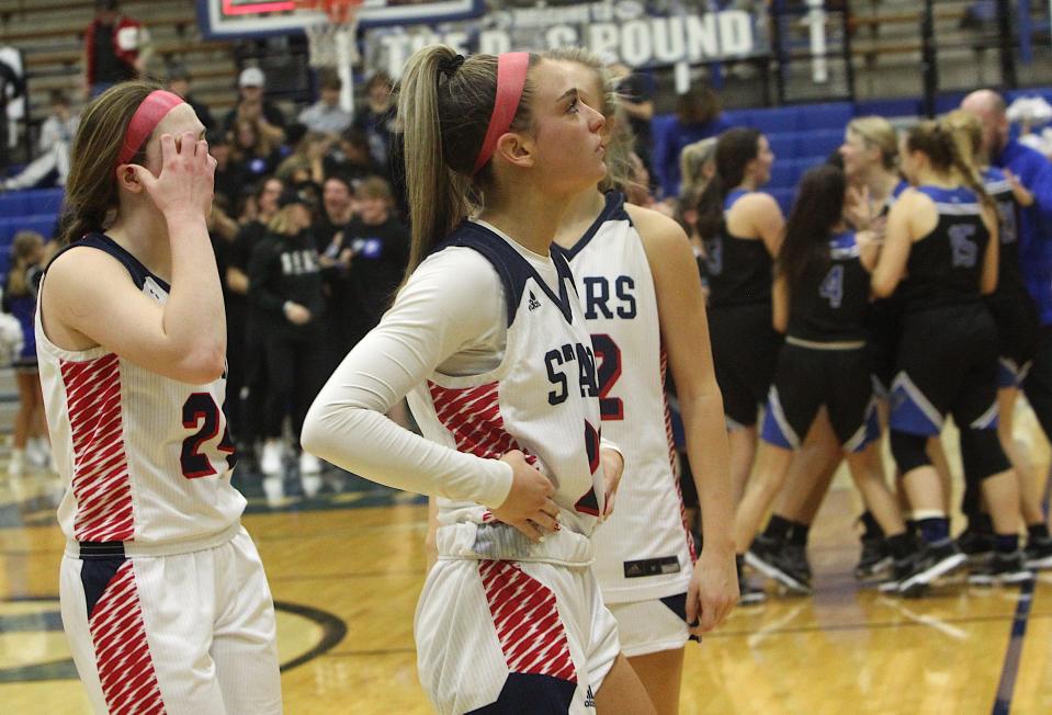 Bedford North Lawrence's Karsyn Norman (21) and Carlee Kern (back) feels the pain following BNL's regional championship loss to Franklin on Saturday, Feb. 12, 2022.