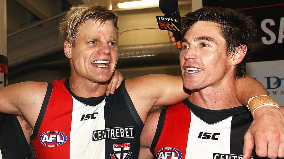 Nick Riewoldt and Lenny Hayes are pictured singing the St Kilda Saints club song.