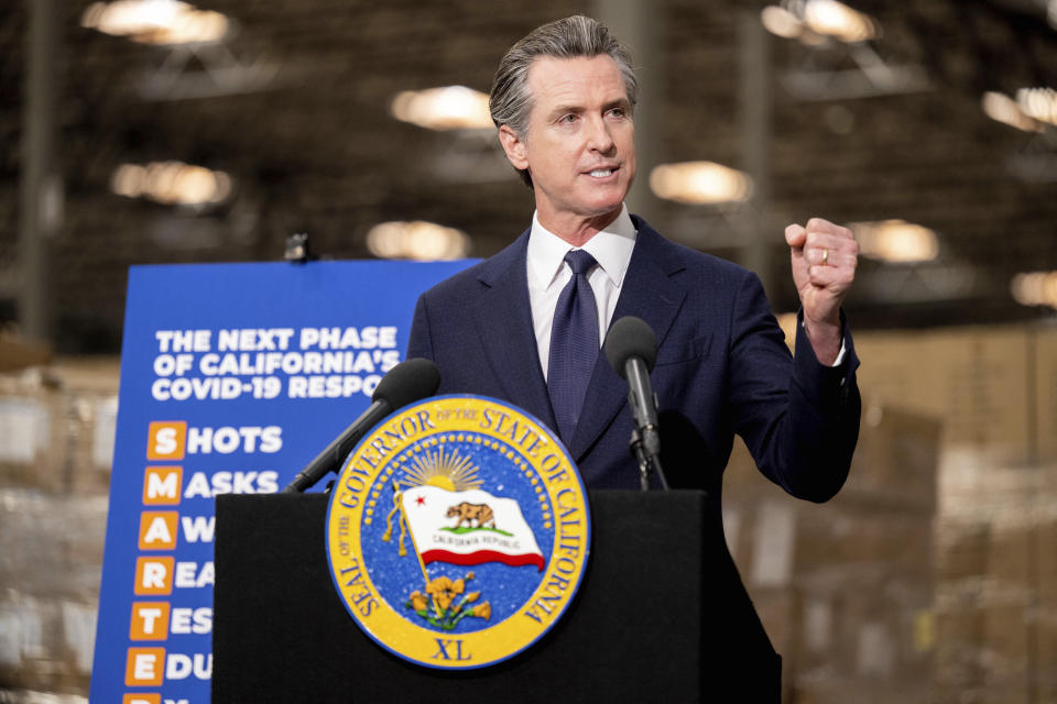 Gov. Gavin Newsom announces the next phase of California's COVID-19 response called "SMARTER," during a press conference at the UPS Healthcare warehouse in Fontana, Calif. on Thursday, Feb. 17, 2022. California Gov. Gavin Newsom on Thursday announced the first shift by a state to an “endemic” approach to the coronavirus pandemic that emphasizes prevention and quick reactions to outbreaks over mandates, a milestone nearly two years in the making that harkens to a return to a more normal existence. (Watchara Phomicinda/The Orange County Register via AP)
