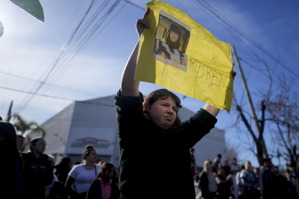 A demonstrator holds a sign that reads in Spanish "Justice for Morena" during a protest against the death of 11-year-old girl Morena Dominguez, who died from her injuries after criminals tried to rob her, outside a police station on the outskirts of Buenos Aires, Argentina, Wednesday, Aug. 9, 2023. (AP Photo/Natacha Pisarenko)