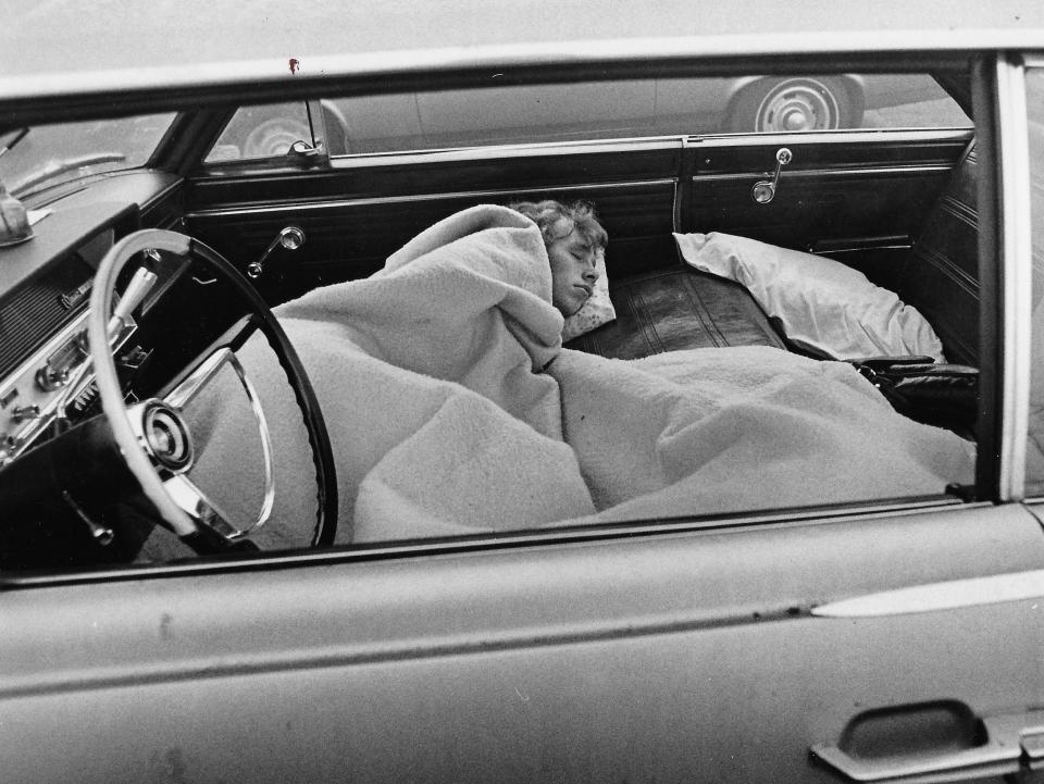 A rock fan sleeps in a car before a 1972 concert at the Akron Rubber Bowl.