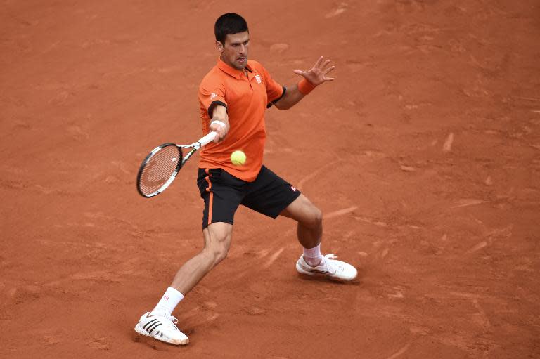 Serbia's Novak Djokovic returns the ball to Finland's Jarkko Nieminen during the men's first round at the Roland Garros 2015 French Tennis Open in Paris on May 26, 2015