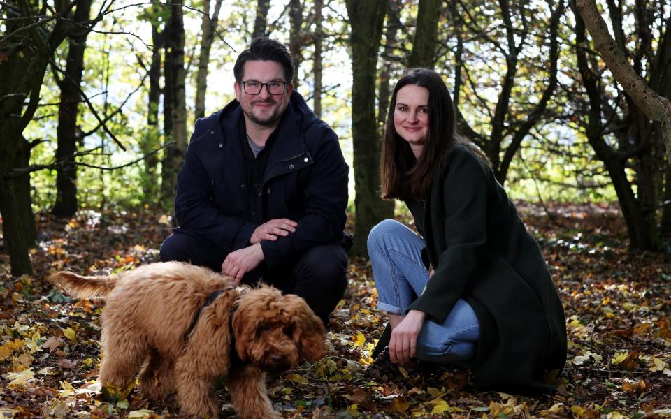 Marie Holt, her partner Paul Clavis, and their red cockapoo dog Otis - Clara Molden