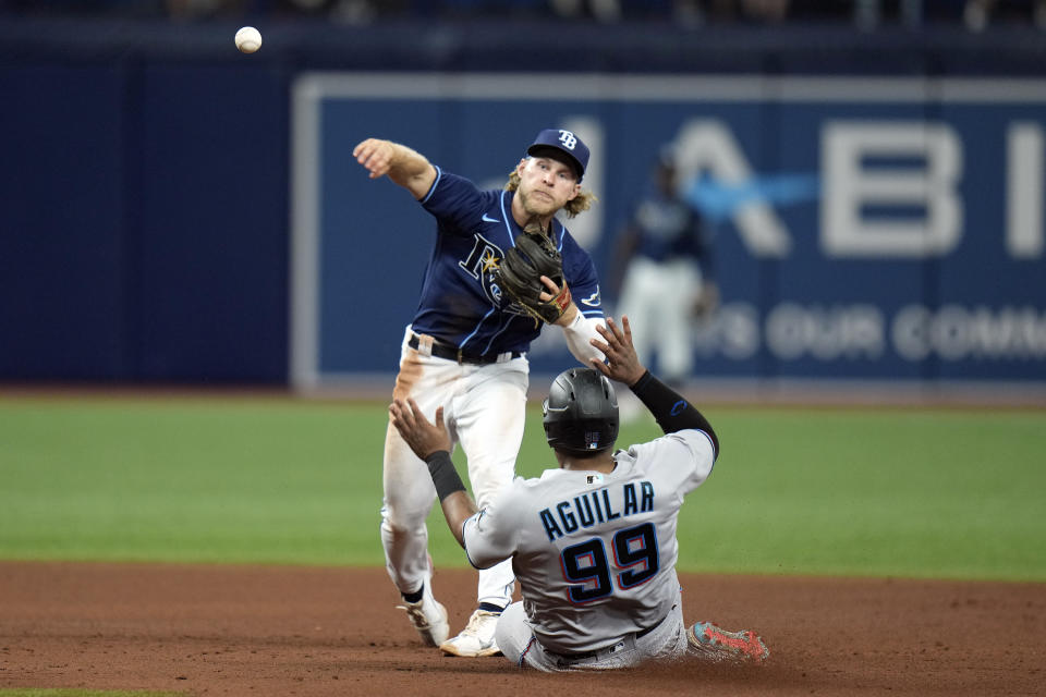 Tampa Bay Rays second baseman Taylor Walls forces Miami Marlins' Jesus Aguilar (99) at second base and relays the throw to first in time to turna double play on Jorge Soler during the sixth inning of a baseball game Tuesday, May 24, 2022, in St. Petersburg, Fla. (AP Photo/Chris O'Meara)