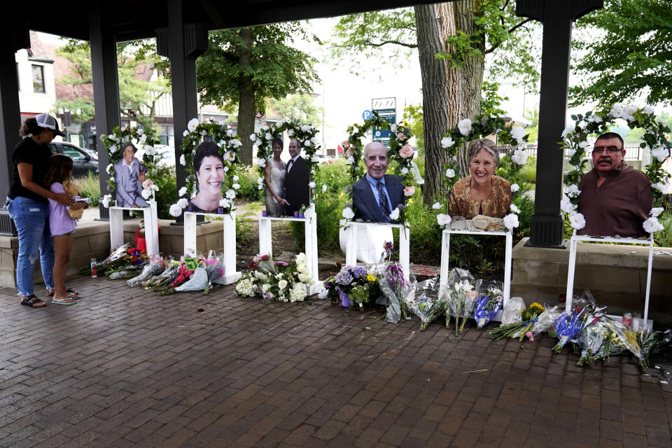 FILE - Visitors pay their respects, Thursday, July 7, 2022, at altars for the seven people killed in the Fourth of July mass shooting in Highland Park, Ill. Robert Crimo III, accused of killing seven people and injuring dozens more, including children, at a Fourth of July parade in suburban Chicago in 2022 is scheduled for a court hearing Wednesday, June 26, 2024, when it is possible he will change his not guilty plea, the prosecutor says. (AP Photo/Nam Y. Huh, File)