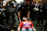 <p>A protester is removed by a Capitol Hill police officer during a Senate Finance Committee hearing on the latest Republican effort to repeal and replace the Affordable Care Act on Capitol Hill in Washington, U.S. September 25, 2017. (Photo: Kevin Lamarque/Reuters) </p>