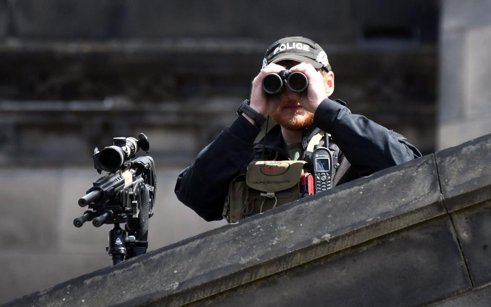 An armed police officer keeps watch on the King's Coronation last year