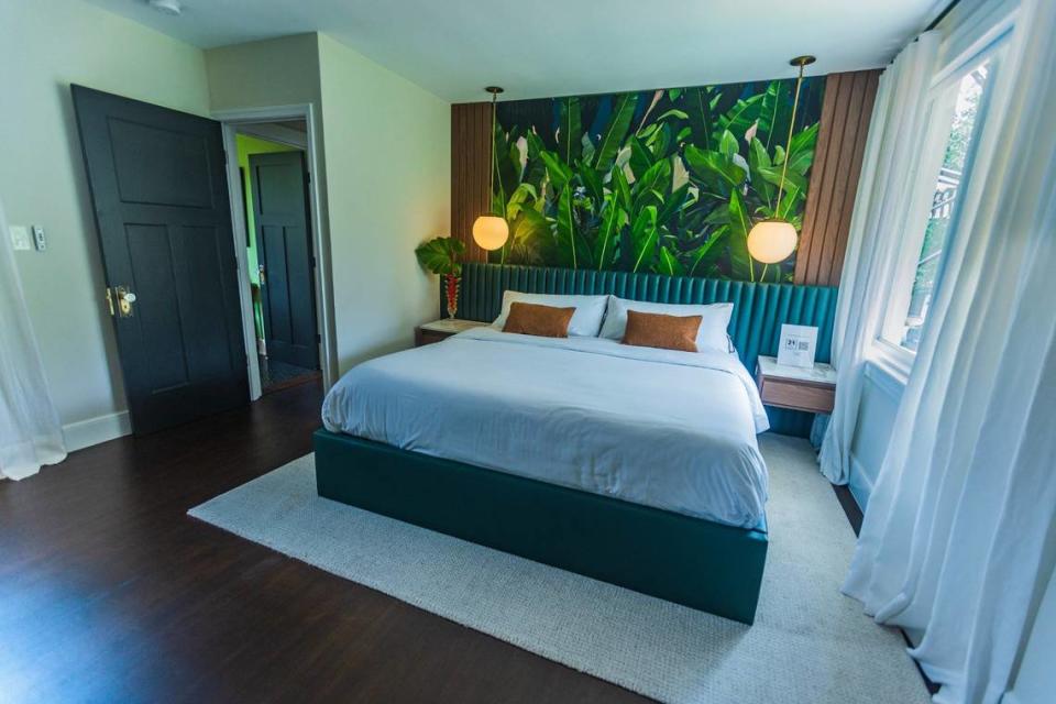 View of the master bedroom at a historic house built in 1925 by architect Marion Manley, who was the first registered woman architect in South Florida. Owners Russ Colombo, Alain Carrazana and their interior designer Lissandra Castillo set themes for each of the three bedrooms, including for the Everglades, another in honor of Manley, and, pictured above, the master suite centered around a painting by Australian artist Robert Bowers.