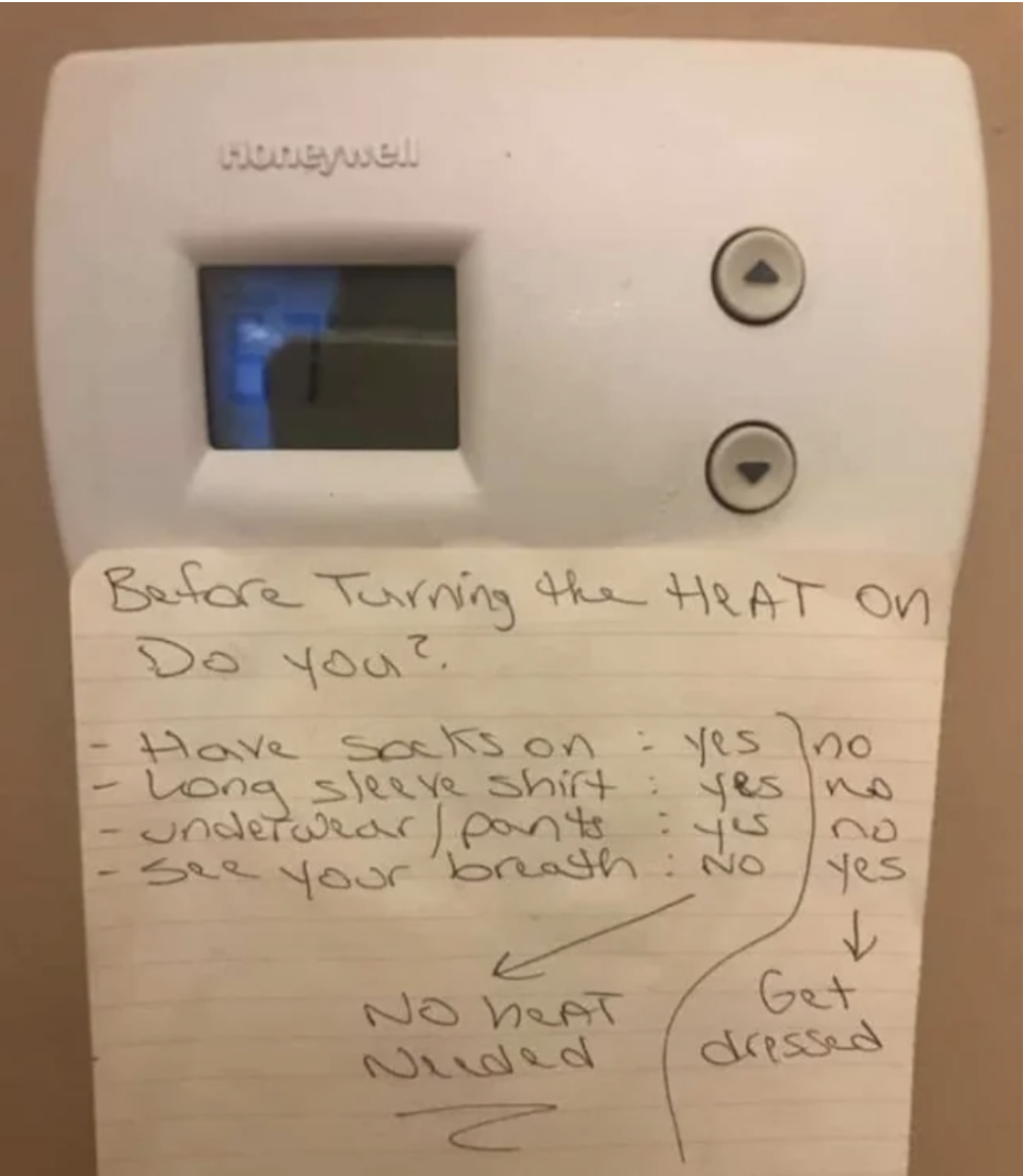 Handwritten note on thermostat "Before turning the heat on, do you" and asking if they have socks on, are wearing a long-sleeved shirt and underwear/pants, can see their breath, and saying to get dressed if they answer yes, not turn the heat on