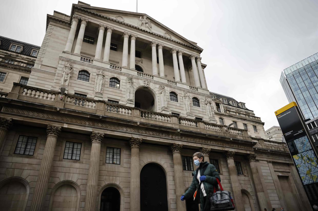 <p>A person walks by the Bank of England wearing a mask as the Chancellor is set to reveal a vaccine funding boost in his Budget</p> (AFP via Getty Images)